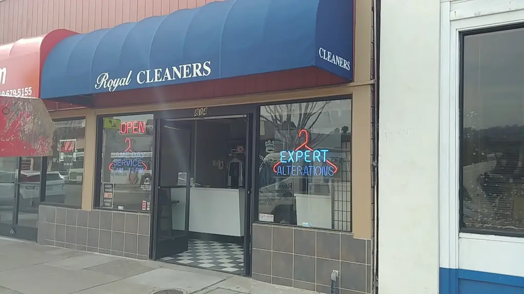 The Royal Cleaners storefront at 814 San Pablo Avenue: a navy awning, neon OPEN and EXPERT ALTERATIONS signs, and the door open onto a checkerboard floor